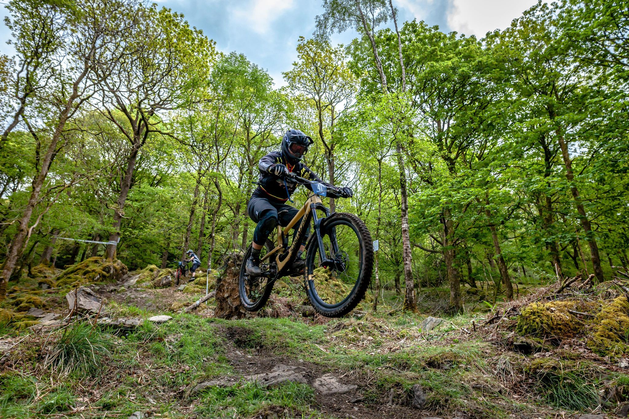 Team EBR rider jumping in woodland