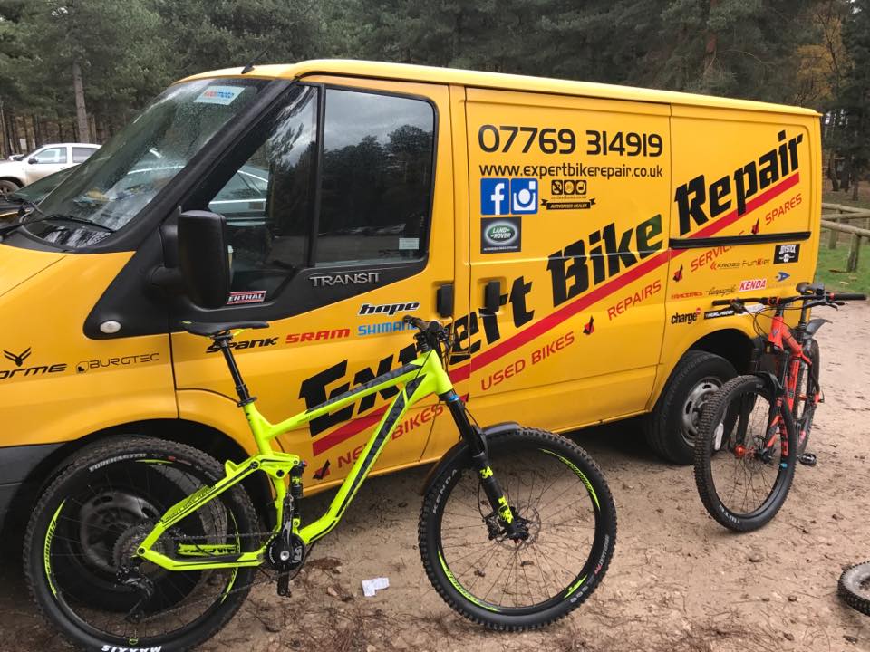 The yellow Expert Bike Repair van with a mountain bike in front of it